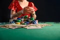 Girl plays cards in a casino, a lot of chips, cards, video. Success and win. Poker Royalty Free Stock Photo