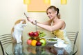 The girl plays with a cat kitchen Royalty Free Stock Photo