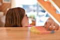 A girl plays with a colorful antistress sensory toy push pop it