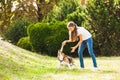 Girl plays with a dog in the yard