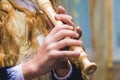 The girl plays the flute, hands close up