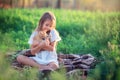 The girl plays with a ginger kitten on the street. Country girl playing with a cat. Child resting on the farm Royalty Free Stock Photo