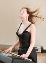 Girl plays keyboard synthesizer Royalty Free Stock Photo