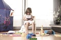 Girl Plays Mobile Phone. The Girl is Hooked to the Mobile Phone. He does not play with toys. The mobile phone is bad for children Royalty Free Stock Photo