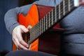 Girl plays an orange acoustic guitar with nylon strings Royalty Free Stock Photo