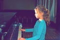 The girl plays piano, close up , white and black keyboard Royalty Free Stock Photo