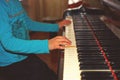 The girl plays piano, close up , white and black keyboard Royalty Free Stock Photo