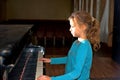 The girl plays piano, close up , white and black keyboard Royalty Free Stock Photo