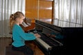 The girl plays piano, close up , white and black keyboard Royalty Free Stock Photo