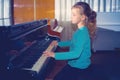 The girl plays piano, close up , white and black keyboard Royalty Free Stock Photo