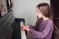 Girl playing piano at musical school