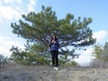 A girl plays a pipe in the forest