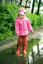 Girl plays in puddle