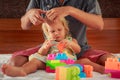 girl plays toy constructor father brushes her hair Royalty Free Stock Photo