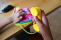 Girl plays a toy phone. Royalty Free Stock Photo