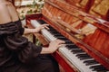 The girl plays the vintage piano at a concert. Royalty Free Stock Photo