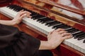 The girl plays the vintage piano at a concert. Royalty Free Stock Photo