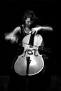 The girl plays a violoncello against a dark background Royalty Free Stock Photo