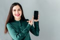 Girl points a finger at the smartphone screen Royalty Free Stock Photo