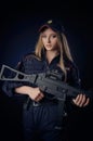 The girl in the police uniform with a gun is a Russian policeman with gun. English translation of Police Royalty Free Stock Photo