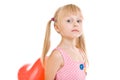 Girl with ponytails hides red balloon behind back