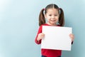 Girl with ponytails and a white sign