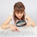 Girl with poor eyesight and computer keyboard