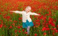 Girl in poppies, happiness and freedom, beautiful spring nature. Happy kid resting on a beautiful poppy field. Child Royalty Free Stock Photo