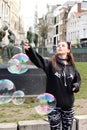 Girl popping bubble in Ghent, Belgium