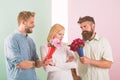 Girl popular receive lot men attention. Men competitors with bouquets flowers try conquer girl. Girl likes to be in Royalty Free Stock Photo