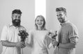 Girl popular receive lot men attention. Girl happy likes gifts. Love triangle. Men competitors with bouquets flowers try Royalty Free Stock Photo