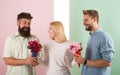 Girl popular receive lot men attention. Woman smiling can not choose partner, grabs both bouquets. Men competitors with Royalty Free Stock Photo