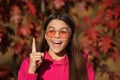 Girl portrait inspired with idea. Autumn teen girl wearing in sunglasses and looks stylish. Fall season. Girl dreams in