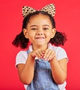 Girl, portrait and leopard headband in studio for fancy dress, pretend play and imagination in red background. Happy