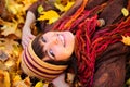 Girl portrait lying in leaves.