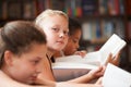 Girl, portrait and reading books in classroom for education, learning and English language, literature or school Royalty Free Stock Photo