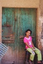 Girl portrait sitting by an old wooden door Royalty Free Stock Photo