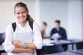 Girl, portrait and teenager with laptop in classroom, back to school and excited for learning. Academy, student and Royalty Free Stock Photo