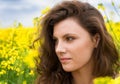 Girl portrait in yellow flower field Royalty Free Stock Photo