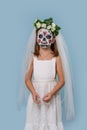 Girl portraying a dead bride with face painting on Halloween