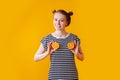 Girl portraying her breast with halves of oranges
