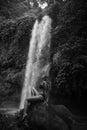A girl poses in a bikini in a waterfall in a forest Royalty Free Stock Photo