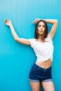 girl posing against blue colorfull wall background