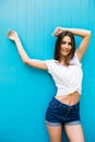 Girl posing against blue colorfull wall background