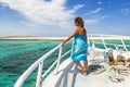 Girl posing on the bow of the yacht in the beautiful sea landscape Royalty Free Stock Photo