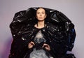 Girl posing in a dress made of plastic film. Fashion portrait.