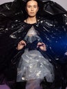 Girl posing in a dress made of plastic film. Fashion portrait.