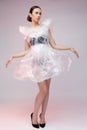 Girl posing in a dress made of plastic film. Fashion portrait.
