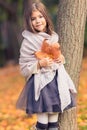 Autumn girl with dry leaves posing