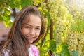 Girl is posing in front of ripe grapes. in sunlight Royalty Free Stock Photo